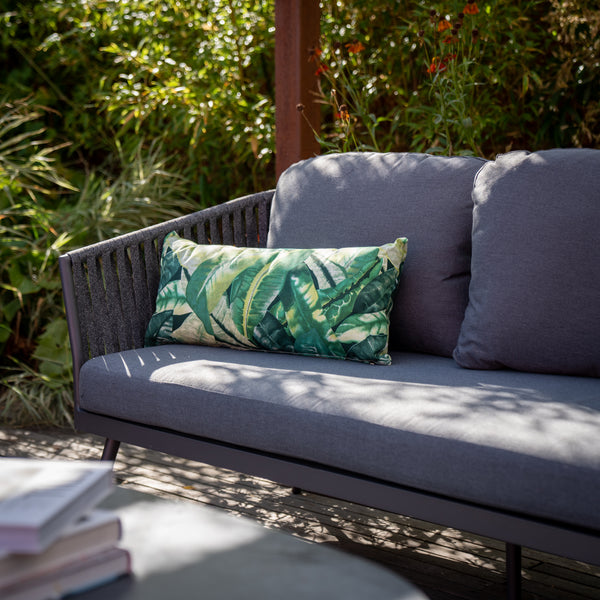 Green Botanical print scatter cushion on grey rope weave sofa