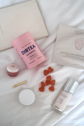 Flat-lay of beauty products, including DIRTEA Gummies