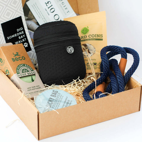 Dog walking gift box containing essential items including strong dog lead, healthy dog treats, carry bag for the dog poop, eco bio degradable poop bags and a £10 gift voucher for a luxury miaboo bed. The gift box is presented in an eco friendly box. 