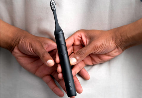 SURI Sustainable Sonic Toothbrush in hands