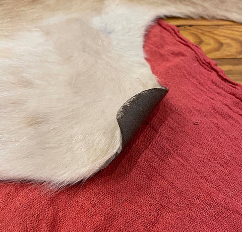 fix cowhide rug curl