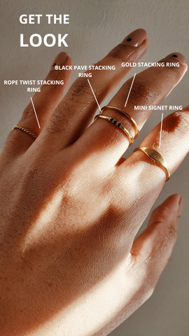 A photo of various gold rings on a hand