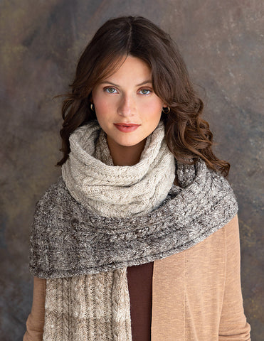 The Akaroa scarf knit with Noro Haunui Silk yarn is drapped around her neck and shoulders.