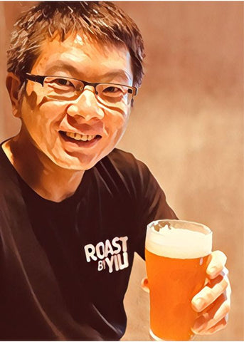 Yili drinking beer after a long hard day roasting