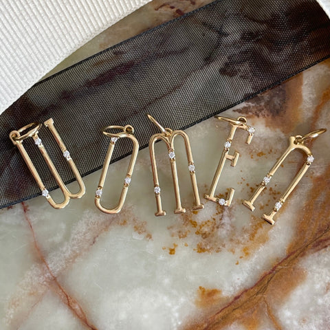 18k yellow gold character letter charms spelling 'women'