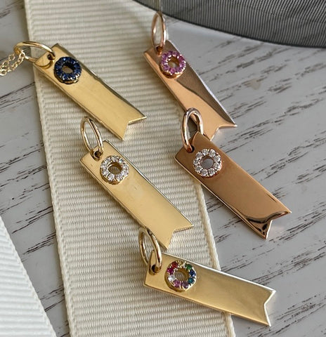 18K gold ribbon charms in diamonds and gemstones