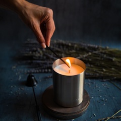Aromatherapy scented candle being lit with a match