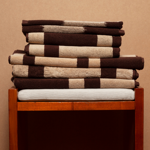 Autumn Sonata Karin towel set folded on wood bench