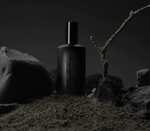 Fischersund 50ml bottle of fragrance with black twig and back backdrop