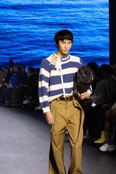 S.S. Daley presented one model in an oversized knit sweater featuring customized Breton stripes and asymmetrical neck collar, combined with flared pleated pants. 