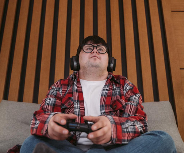 Someone playing a video game wearing flannel shirt