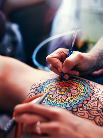 tattooing a mandala tattoo on a man
