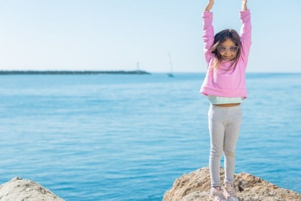 Child outdoor mountain pose beach sea - Rainbow Kids Yoga Teacher Training