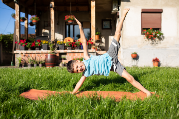 boy stretch outside grass mat rainbow kids yoga teacher training relaxation visualization