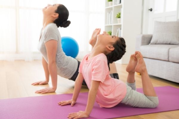 Mom daughter home yoga - Rainbow Kids Yoga Teacher Training