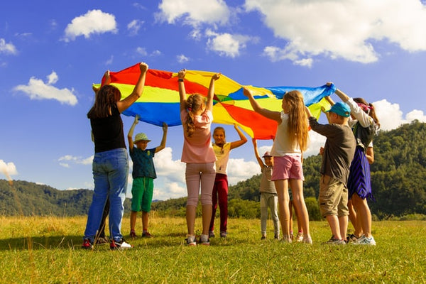 Children play outside field fun - Rainbow Yoga Training