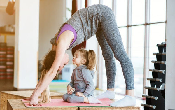 down dog yoga mother with daughter little girl kiss - rainbow yoga training
