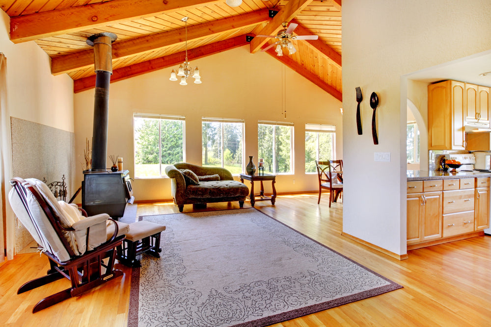 A living room featuring beautiful large rug over a light hardwood floor