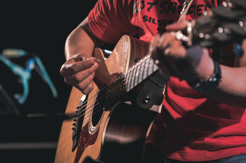 ライブハウスでギターを演奏する男性