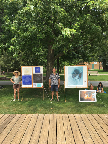 Artists Samuel Choisy and Carolina Reis showing their work in the park.