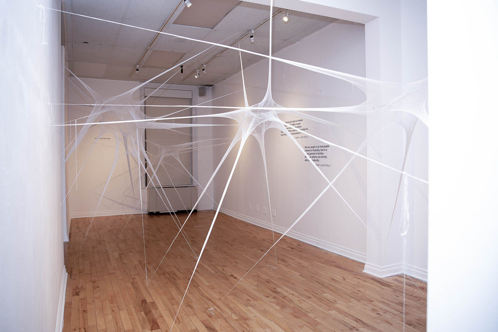 Overview of the installation showing 3D sculpture made of fine knitted thread