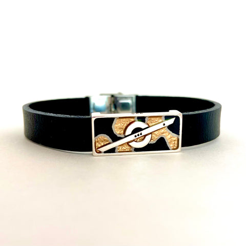 Stoke Saver hand-painted bead for The Fun Wheel brand in gold, metallic black , and white pin-stripes, black leather band