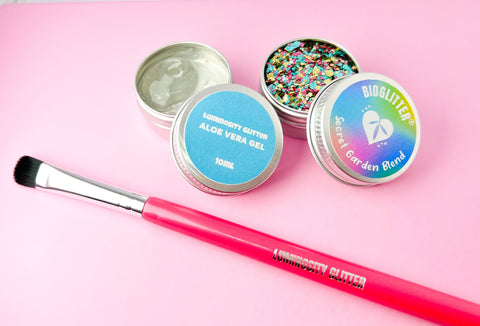 Secret Garden Eco Glitter Set with an aloe vera application gel and hot pink makeup brush