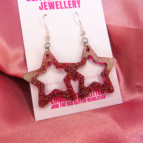 Biobased resin glitter earrings as part of Luminosity Glitter's Glitter Amnesty on a pink backing card.