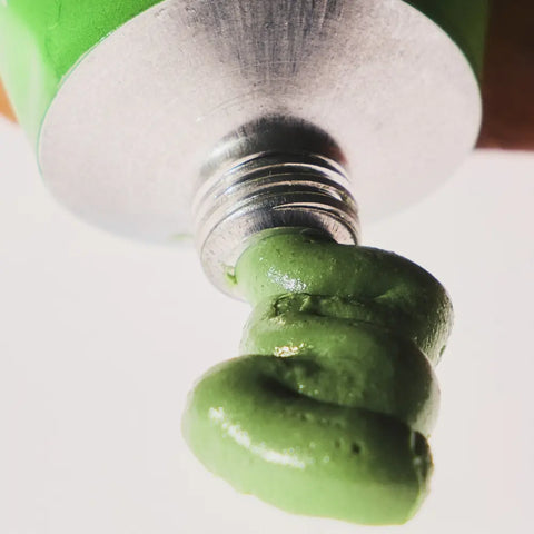 Willow bark extract-based green skincare product being dispensed from a tube for topical application