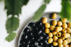 Green and black olives on a plate