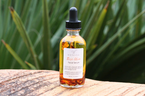 Rose Glow Facial Serum in glass dropper bottle with dried rose petals