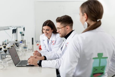 Scientists looking at a computer