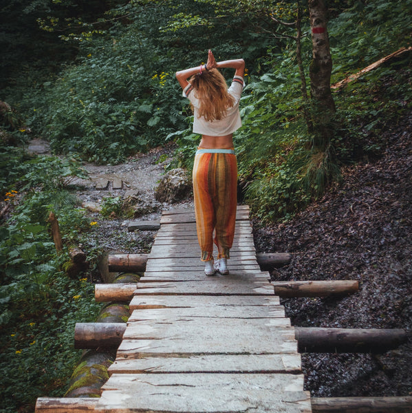 woman with hands praying in the forest