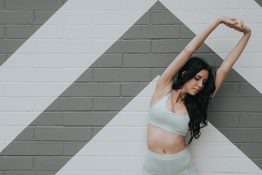 woman standing stretching her arms