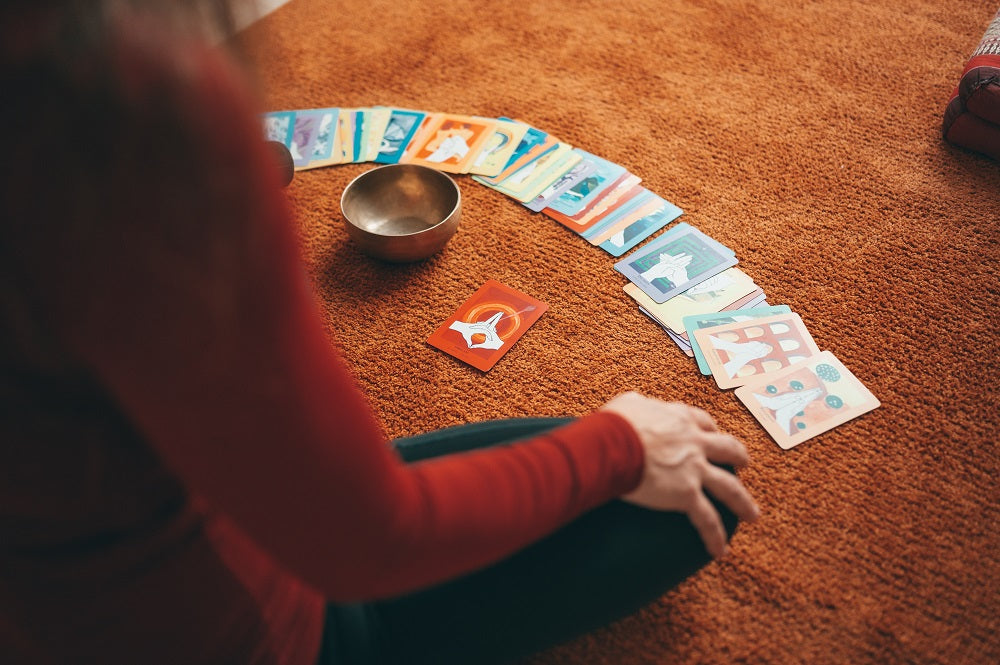 woman in front of her deck of tarot cards