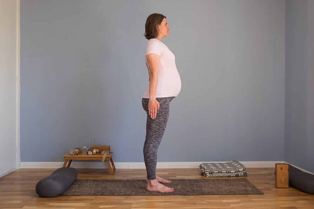 femme enceinte dans la posture de yoga de la montagne