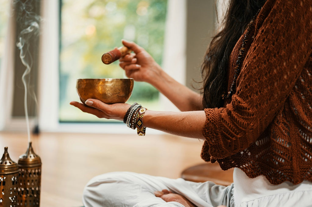 woman playing Tibetan bowl