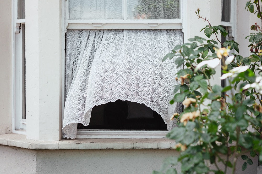 open window with curtain in the wind