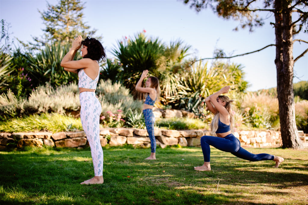 group of young women practicing yoga