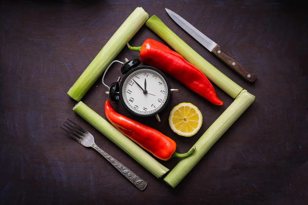 clock surrounded by vegetables