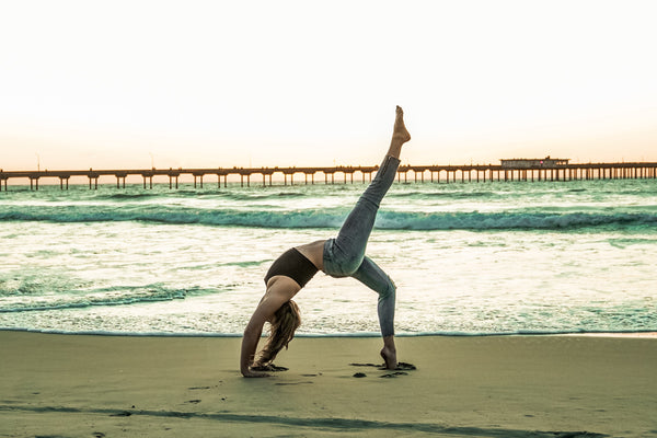 young woman in wheel yoga pose