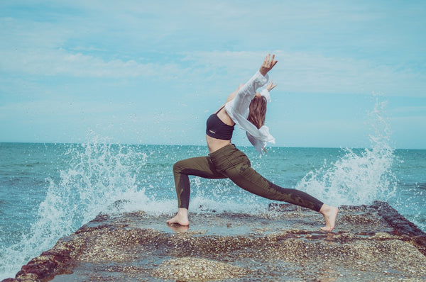 young woman in warrior yoga pose I