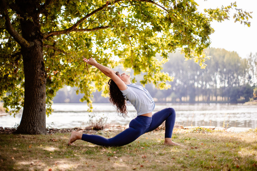 young woman practicing yoga in the shade