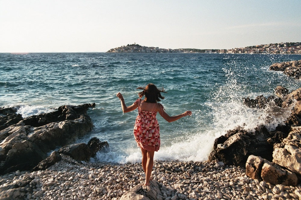 young woman on a pebble beach