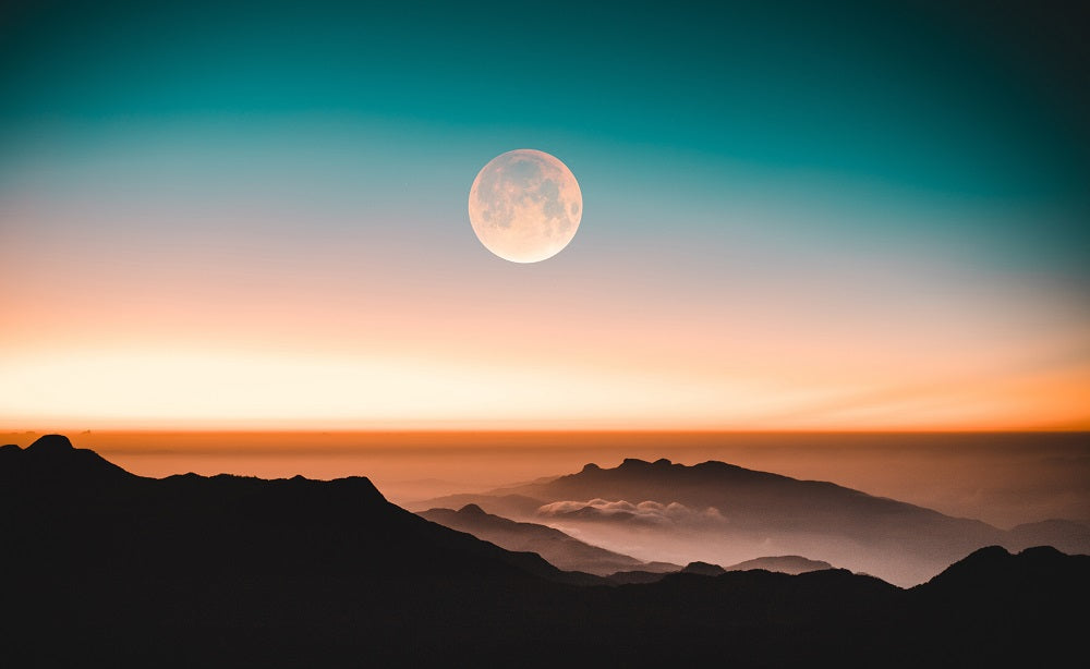 full moon over the mountains