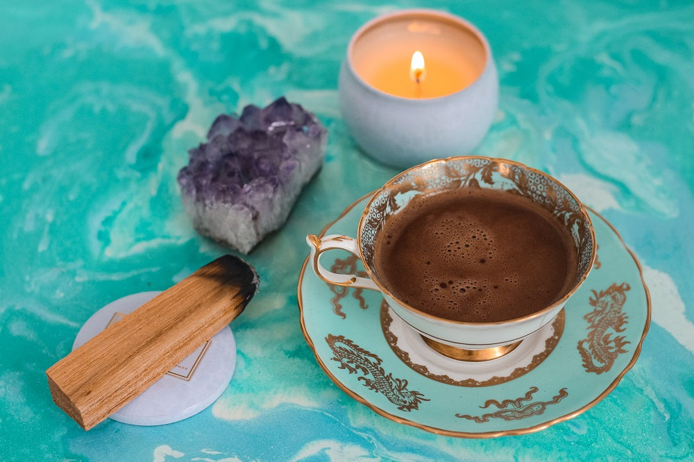 cup of tea with palo santo and candle