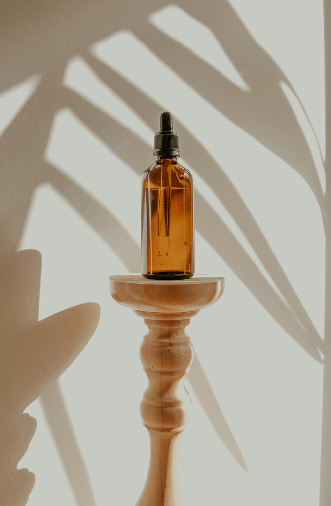 a bottle of cannabidiol oil with shadow play