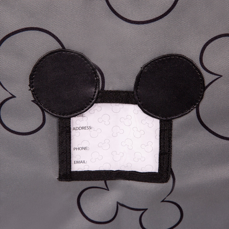 Close up picture of Mickey shaped ID tag on the Disney Baby Ultimate Padded Backpack Car Seat Travel Bag, Mickey Grey