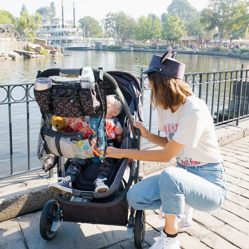 Disney Baby Cups ‘N Cargo Stroller Organizer hanging on stroller