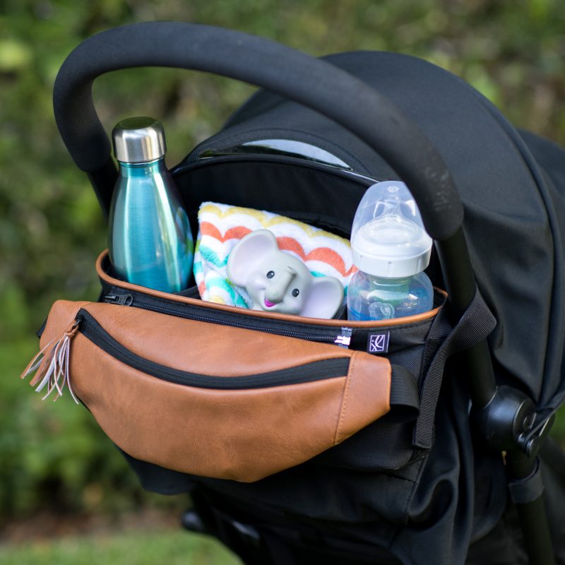 Stroller Organizer with Hip Pack hanging on stroller with accessories in it